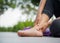 Young woman massaging her painful foot from exercising