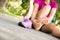 Young woman massaging her painful foot from exercising