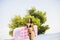 Young woman with a mattress on the beach