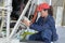 Young woman mechanic working on machinery