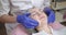 Young woman in medical hat, lying on a medical couch at cosmetology office. Young lady doctor in medical mask and gloves