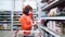 Young woman in medical mask buying grains in shopping center