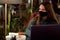 Young woman in medical mask in cafe with laptop