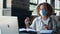 Young woman in medical mask takes precautions and wears medical mask on face during online distance training sitting in