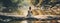 A young woman is meditating by the lake