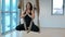 Young woman meditating sitting in hammock for yoga indoors.