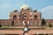 Young woman meditating in the yard of Humayun\'s Tomb. Delhi