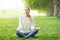 Young woman meditating and Yoga in a park