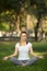 Young woman meditation in city park. Yoga exercise