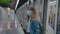 Young woman at metro stop in coronavirus face mask