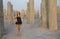 Young woman in a middle of concrete pilings