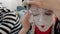 Young woman mime artist removing make-up and face paint after performance