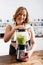 Young woman mixing green smoothie in