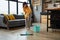 Young Woman Mopping Floors at Home