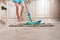 Young Woman Mopping Kitchen Floor