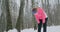 A young woman on a morning jog in the winter forest was tired and stopped to rest and ran on. He recovered his strength