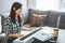Young woman music teacher playing electric piano teaching remotely using laptop while working from home. Online education