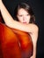 Young woman naked by double bass