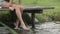 Young woman in nature relax seated on lake jetty in summer day outdoor