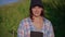 young woman in nature in sunny day, walking in orchard in farm