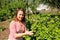 Young woman near a bush currants