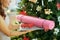 Young woman near Christmas tree holding fitness gear