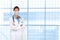 Young woman nurse or doctor with a blurry modern medical facility background, with copy space