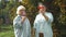 Young woman and old senior woman with glass of wine in vineyard on sunny day. A group of girlfriends raise a toast with