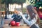 Young woman open her bag in cafe outside