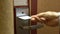A young woman opens the door of his hotel room using an electronic key card.