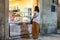 A young woman orders food from a sidewalk cafe in Diocletians Palace, Split Croatia