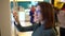 A young woman orders food at the touch terminal in a shopping center. Modern technology. On the food court without