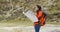 Young woman out hiking checking a map