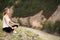 Young Woman Outdoor Meditation. Sitting on the Mountain.