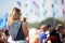 Young Woman At Outdoor Music Festival Using Mobile Phone