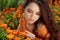 Young woman outdoors portrait over orange marigold flowers