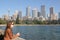 Young woman overlooks the bay and skyline of Sydney