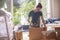 Young woman packaging carton boxes and planning to move to a new house