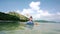 Young woman paddling a canoe on the sea during summer vacation in Indonesia