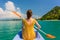 Young woman paddling a canoe during vacation in Flores Island