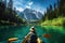 Young woman paddling a kayak on the lake of Braies, Dolomites, Italy, Beautiful woman kayaking on a beautiful mountain lake with