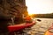 Young Woman Paddling the Red Kayak on Beautiful River or Lake near High Rocks at Sunset