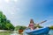 Young woman paddling during vacation in an idyllic travel destin