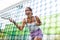 Young woman padel tennis player trains on the outdoor court