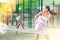 Young woman padel tennis player trains on the outdoor court