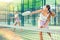 Young woman padel tennis player trains on the outdoor court