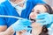 Young woman during painless oral treatment in a modern dental office