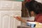 Young woman painting furniture at home