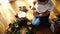 Young woman paints a fir cone with a brush for a New Year wreath