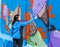 A young woman paints a picture with a paintbrush on a concrete security fence on the border between Israel and Lebanon.